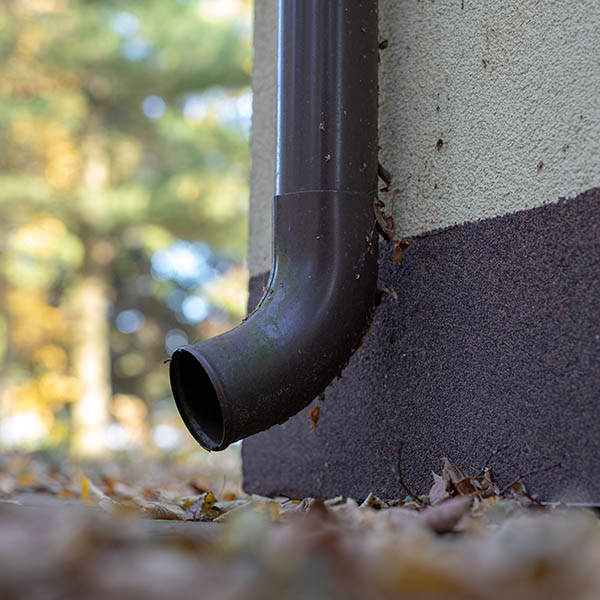 Gutter draining rainwater. The building is equipped with drainage of rainwater from the roof. Season of the summer.