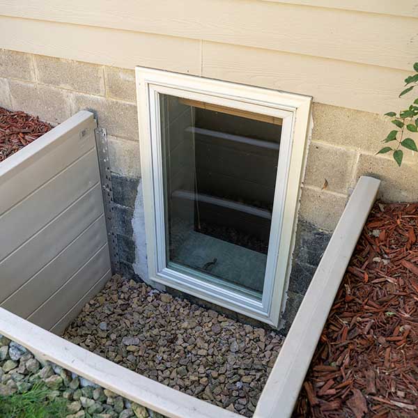 Exterior view of an egress window in a basement bedroom. These windows are required as part of the USA fire code for basement bedrooms